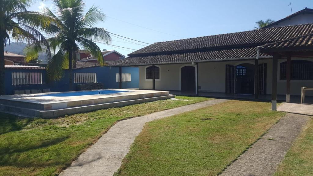uma casa com piscina num quintal em Casa Aconchego com PISCINA em Ubatuba