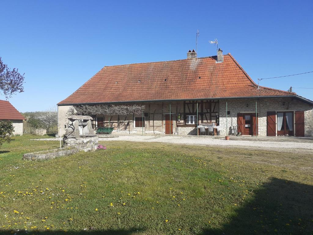 an old building with a red roof on a field at commealaferme71.vacances in Montret