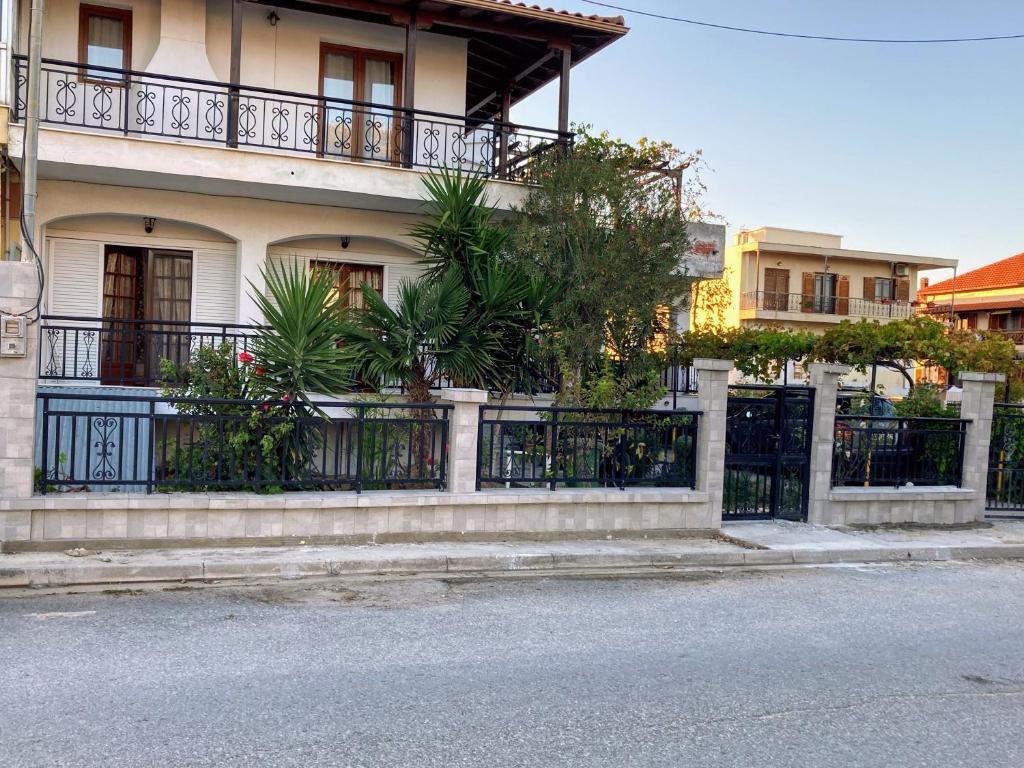 a house with a fence and plants in front of it at Kristel in Ierissos