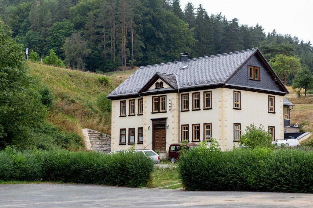 a large white house with a black roof at Orgelbauerhaus Schulze in Königsee