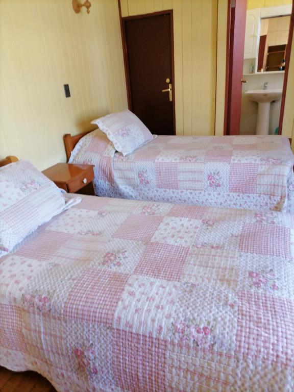 Postel nebo postele na pokoji v ubytování Hostal Emalafquen