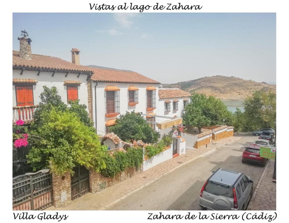 a row of houses on a street with cars parked at CASA GLADYS in Zahara de la Sierra