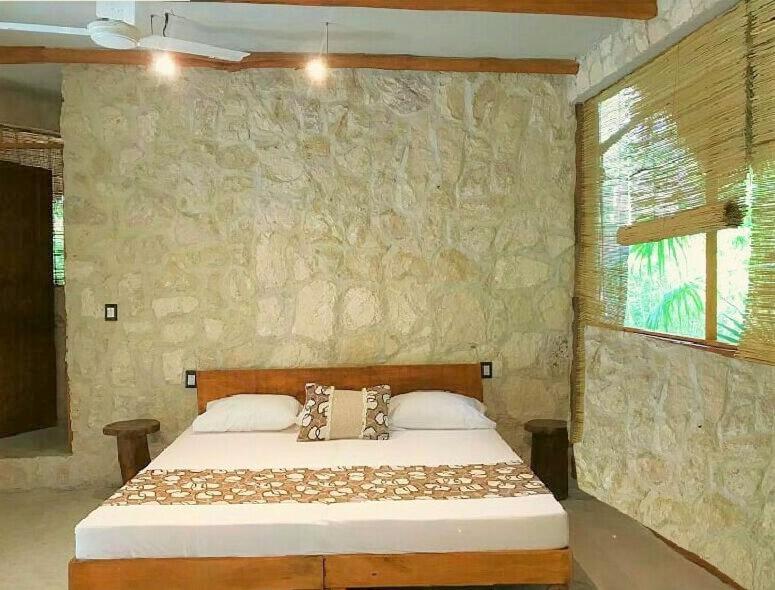 Postel nebo postele na pokoji v ubytování Aldea Maya-Ha Cabañas con cenotes
