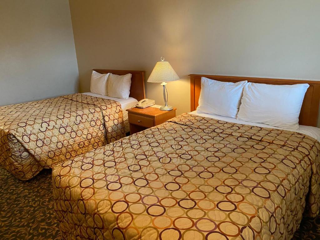 Postel nebo postele na pokoji v ubytování Aspen Motor Inn