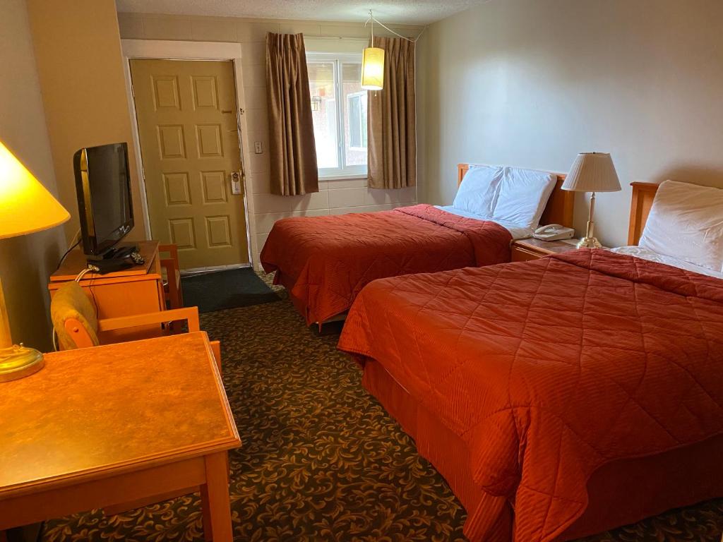 Postel nebo postele na pokoji v ubytování Aspen Motor Inn