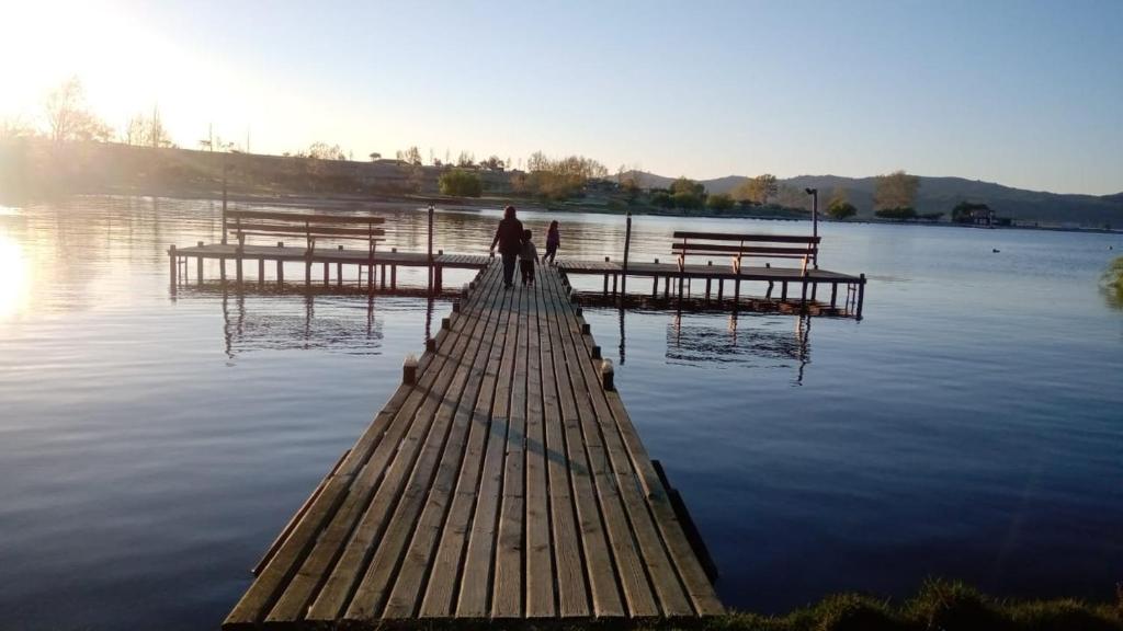 a person standing on a dock in the water at Cabaña Rapel Privada in Rapel