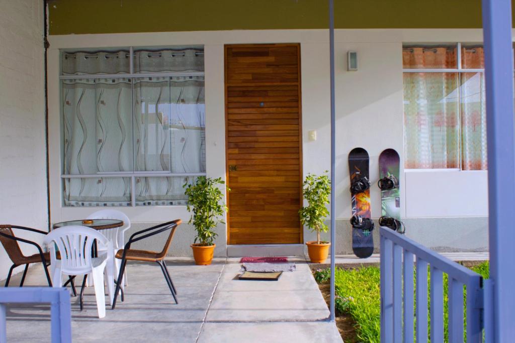 a house with a patio with a table and chairs at SUNRISE home in Ica