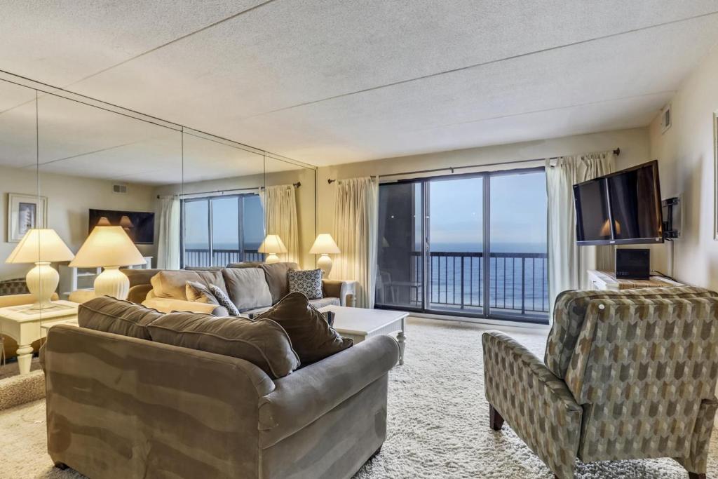 a living room with a couch and a television at Rainbow Condos II in Ocean City