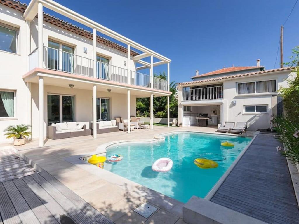 a swimming pool in the backyard of a house at Enticing villa in Juan les Pins near the beach in Juan-les-Pins
