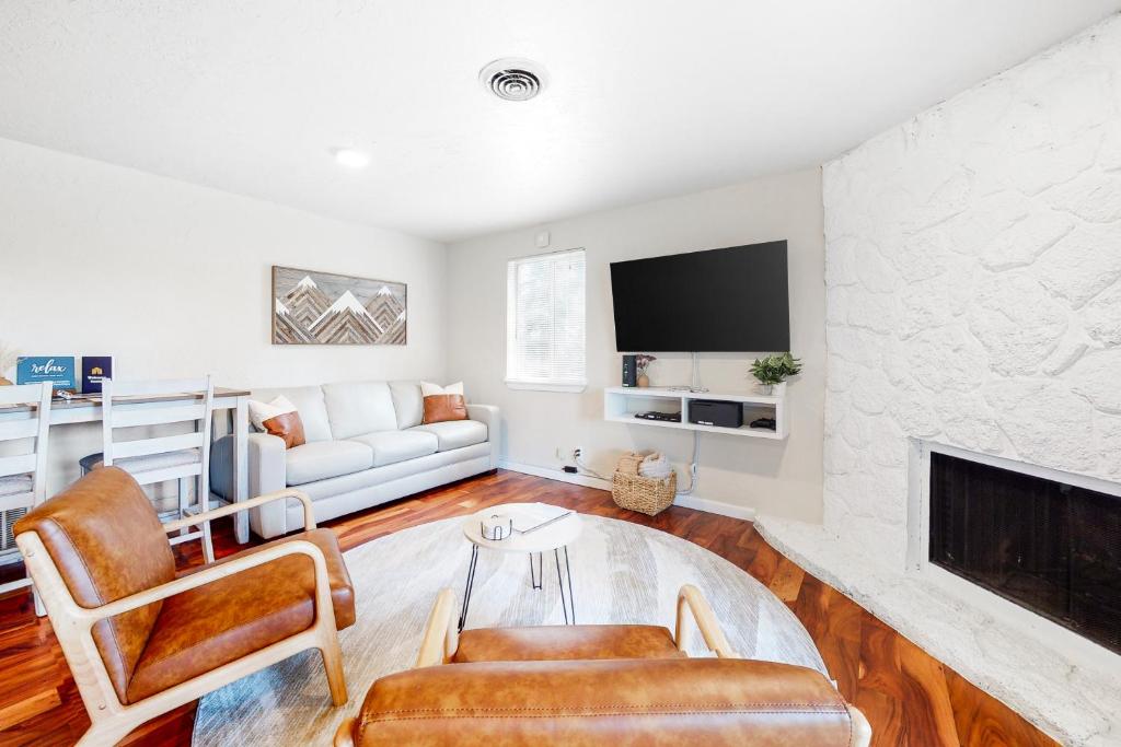 a living room with a couch and a fireplace at Snow Pine Getaway in Sunriver