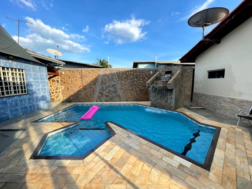 a swimming pool in the middle of a house at Casa Galaxy in Boa Vista