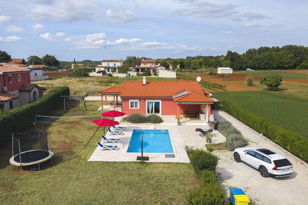 eine Luftansicht eines Hauses mit Pool und Stühlen in der Unterkunft Villa Kata in Rebići