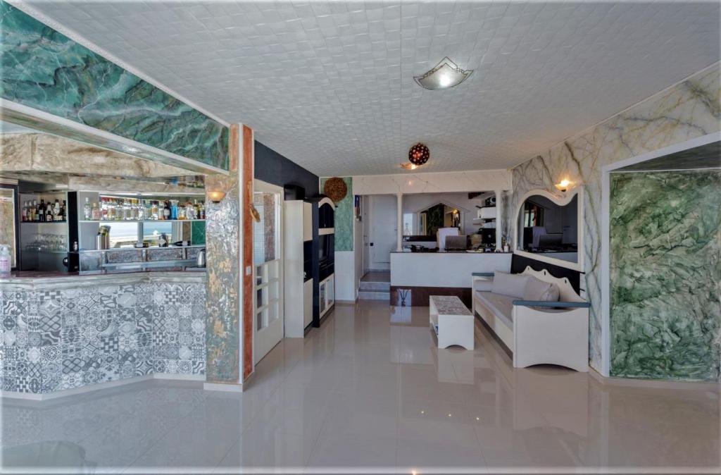 a living room and a kitchen in a house at Magnificent Views Suite in Hersonissos