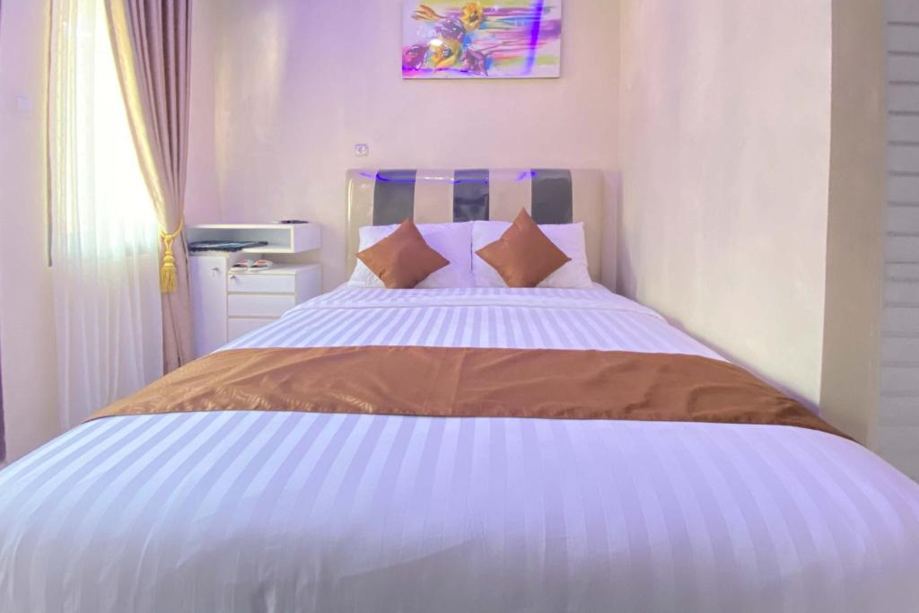 Postel nebo postele na pokoji v ubytování Homestay Banteng Adventure Dieng Mitra RedDoorz