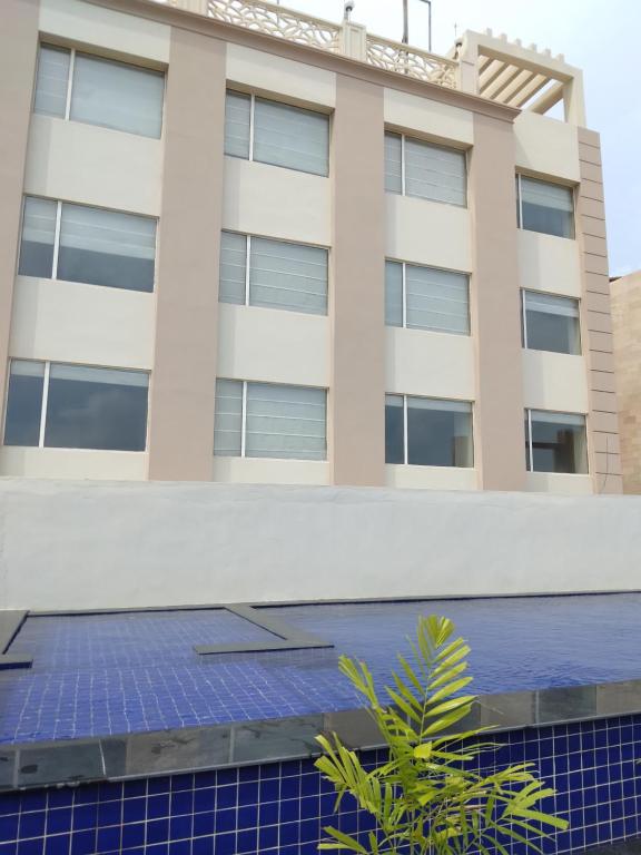 a building with blue solar panels in front of it at HOTEL NILADRI PREMIUM in Puri