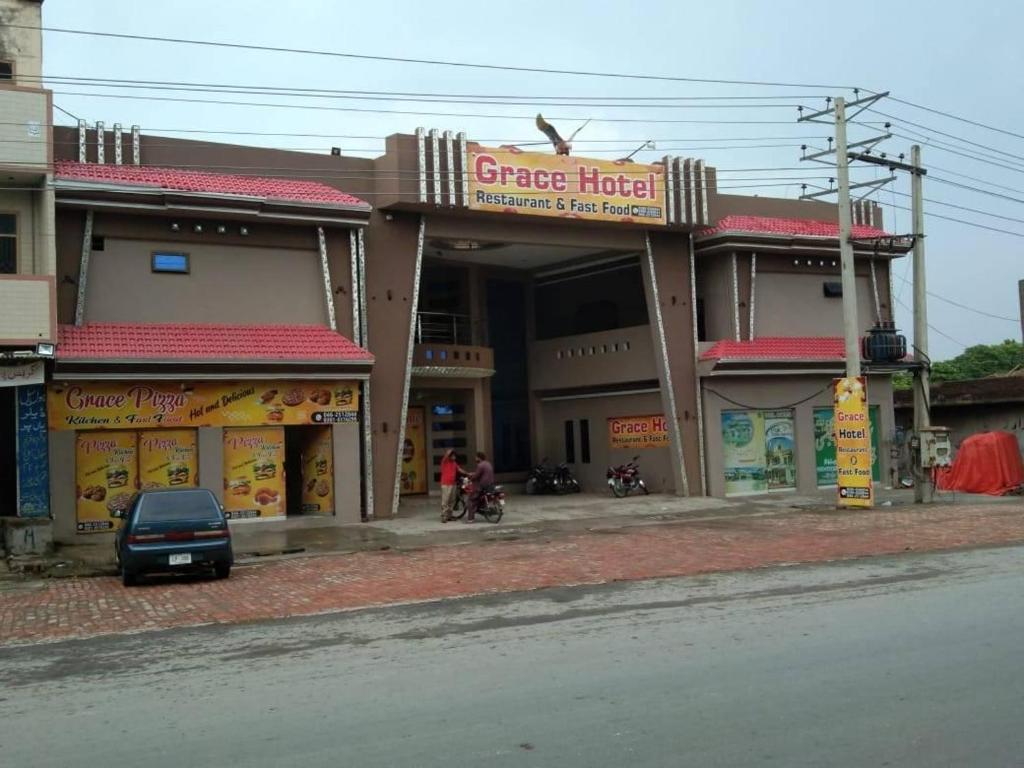 a car parked in front of a building at Grace Hotel in Gobindpur