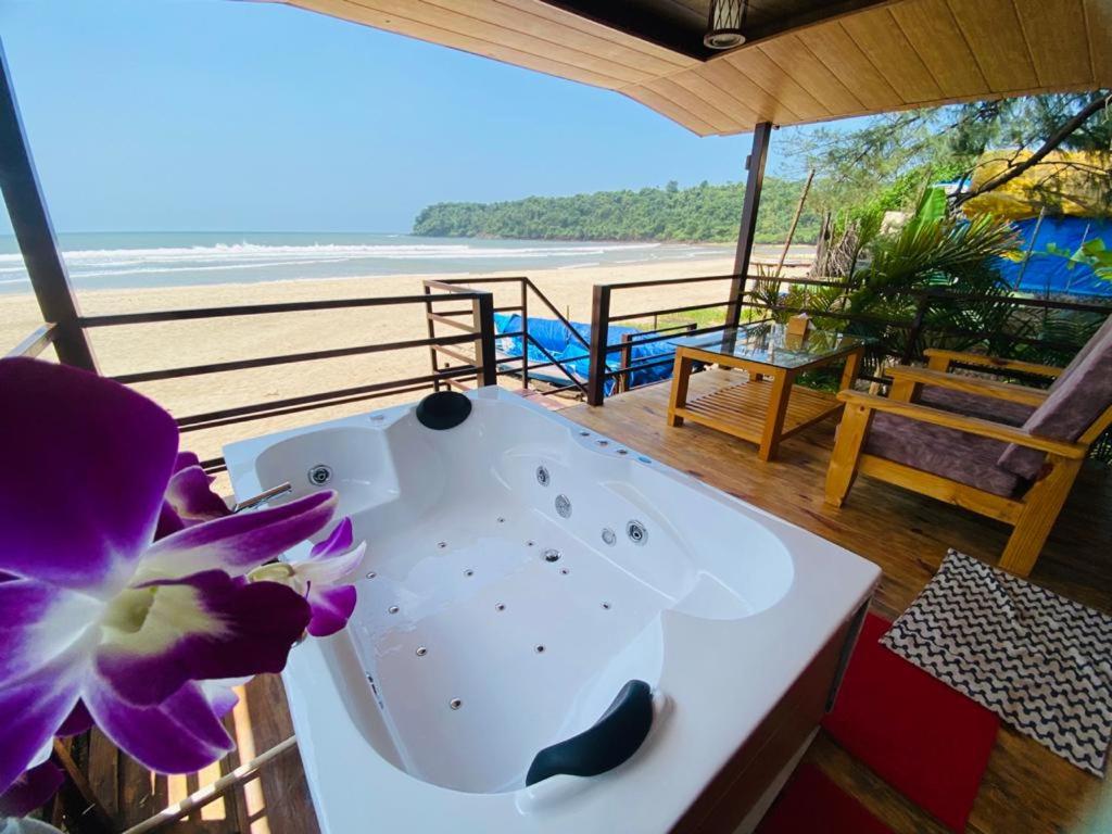 a white bath tub sitting on top of a beach at Agonda Serenity Beach Villa in Agonda