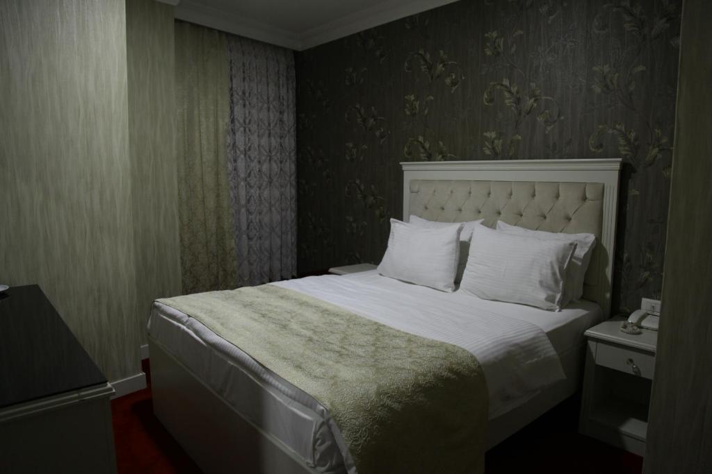 Ένα ή περισσότερα κρεβάτια σε δωμάτιο στο Ens Hotel