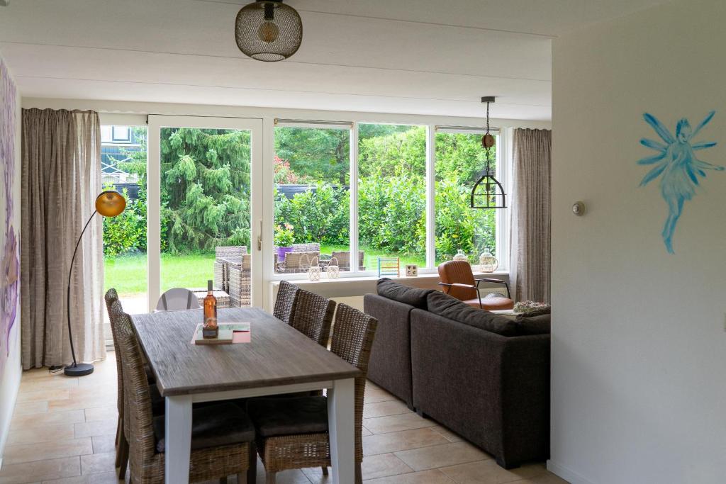 een woonkamer met een bank en een tafel bij Kom in de Bedstee Magie! in Winterswijk