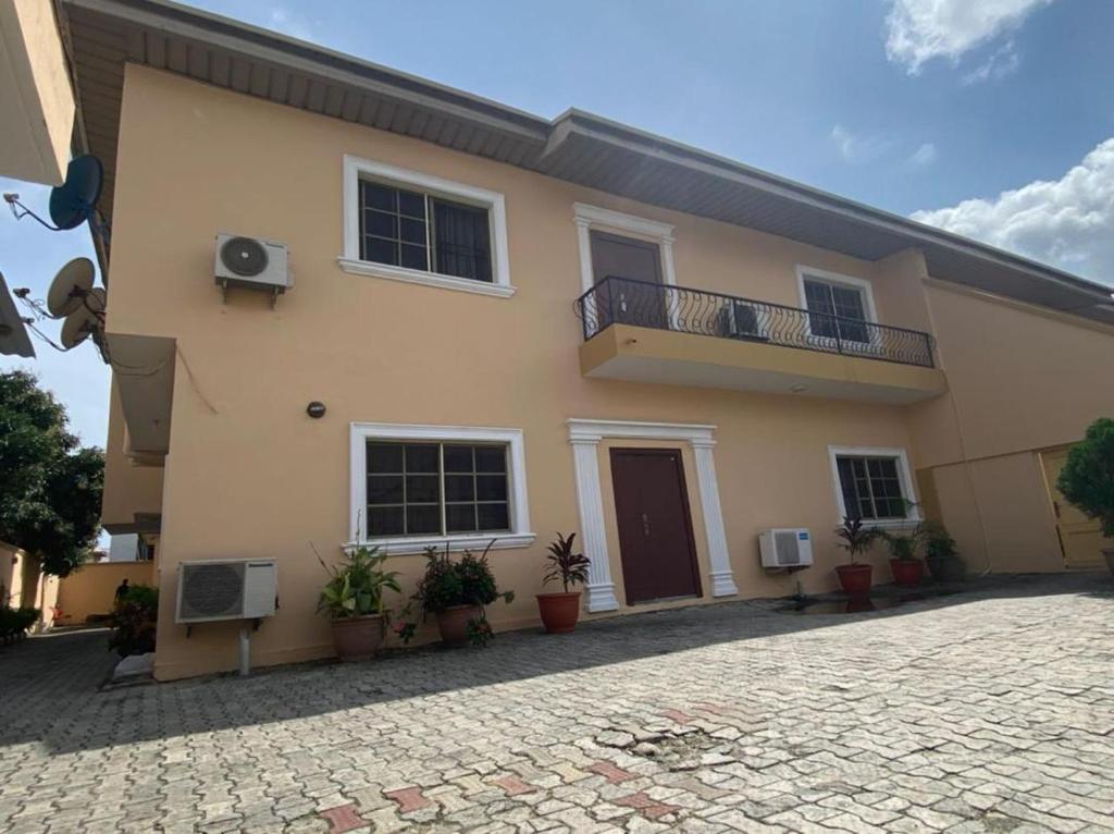 a large house with a balcony and a patio at Vintage Homes Lekki in Lagos
