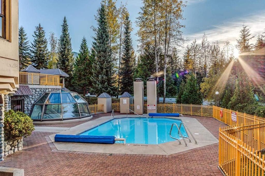 a swimming pool in a yard with a fence at Marquise by Whistler Blackcomb Vacation Rentals in Whistler