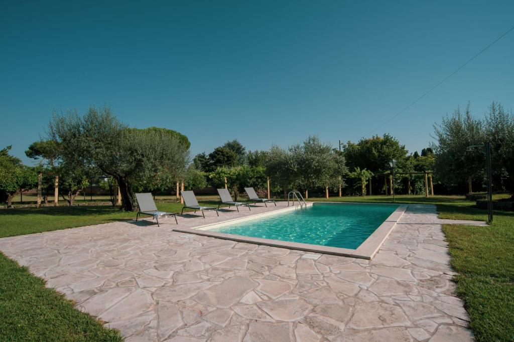 a swimming pool with lounge chairs next to at Casale Barbi in Velletri