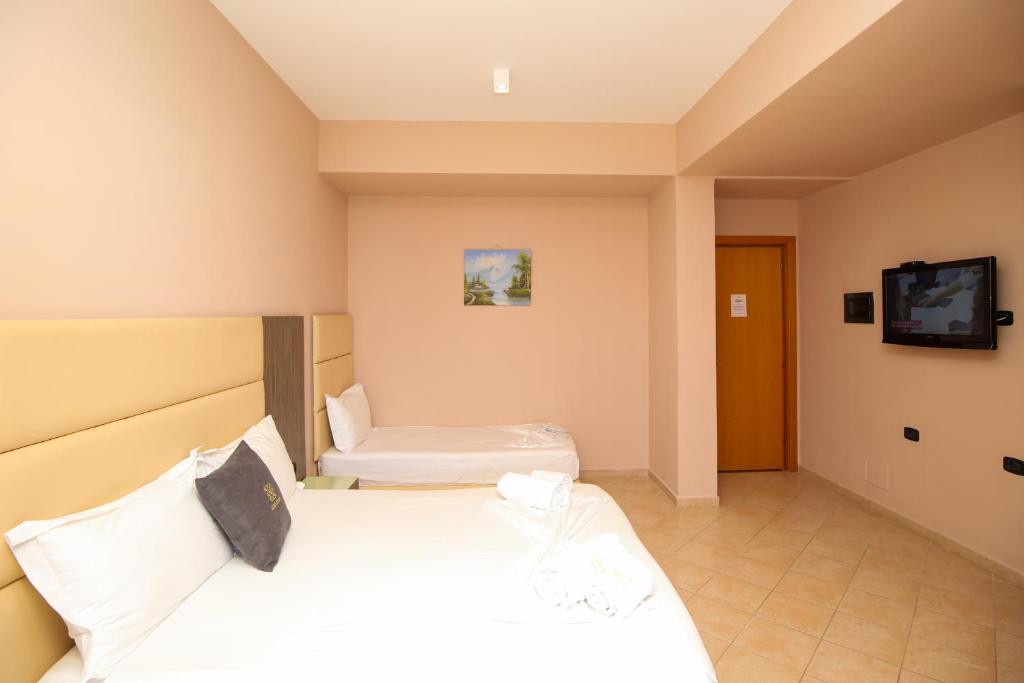 Postel nebo postele na pokoji v ubytování Aliko Hotel
