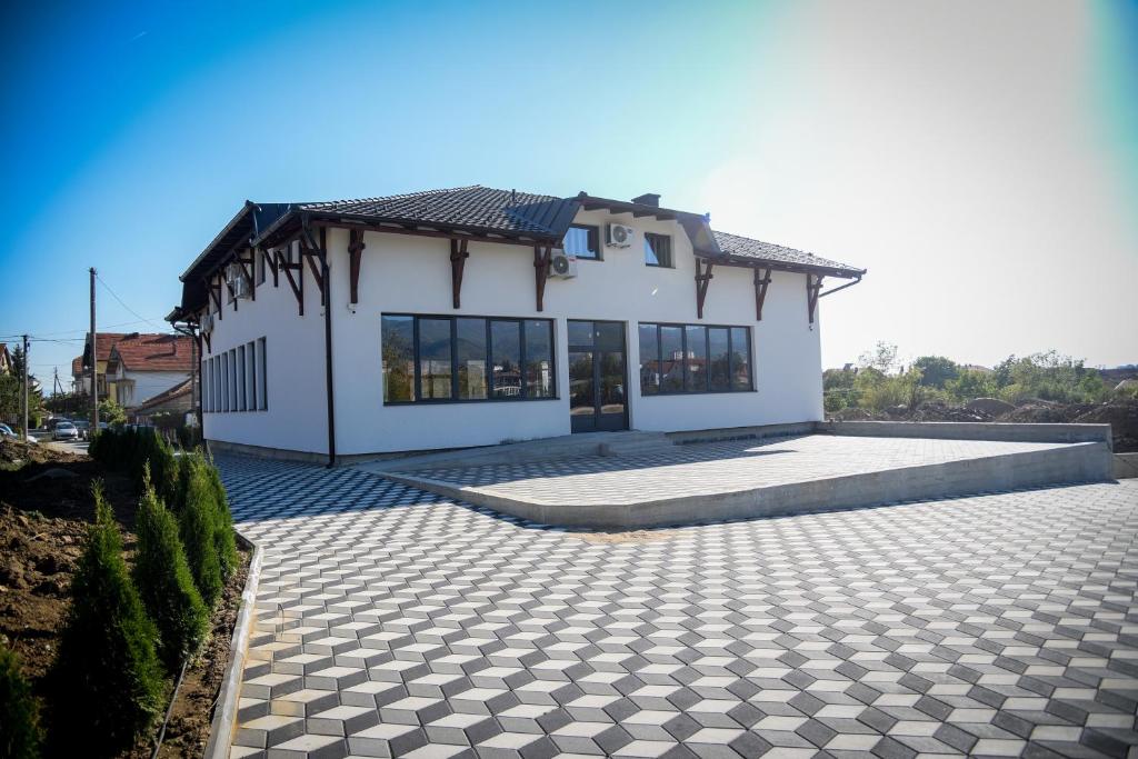 a white house with a stone driveway at Prenociste ADRIA in Vranje