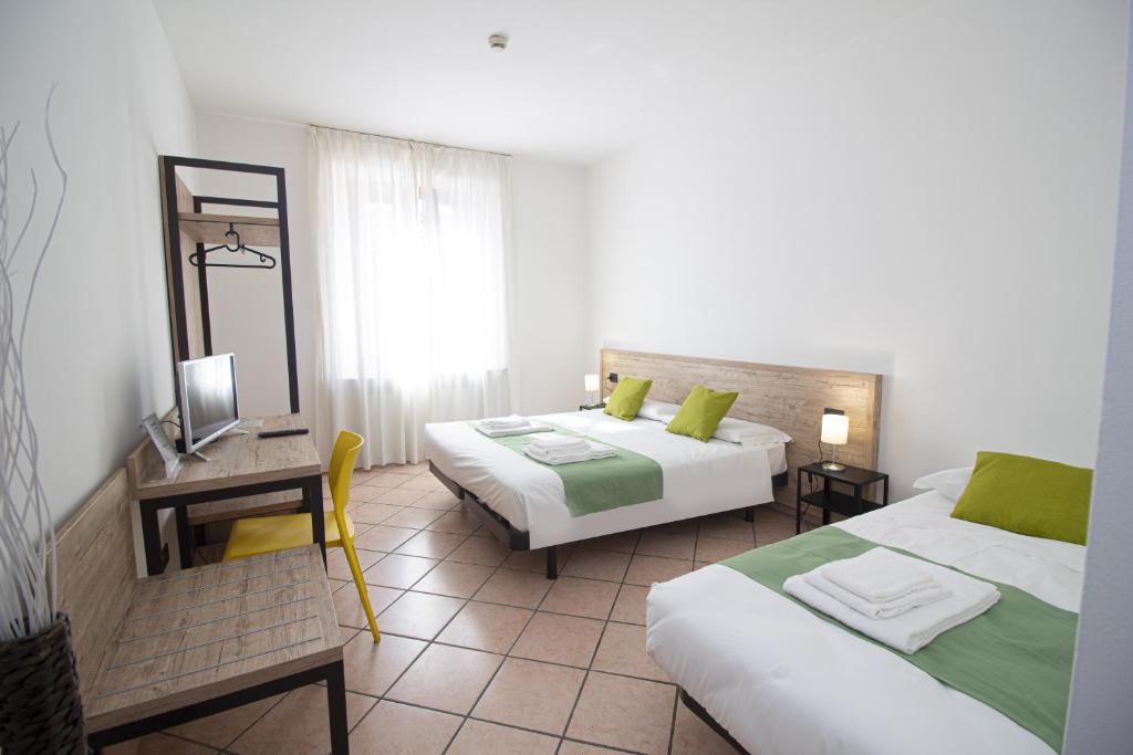 Postel nebo postele na pokoji v ubytování Hotel Tornielli 9 by LVG Hotel Collection
