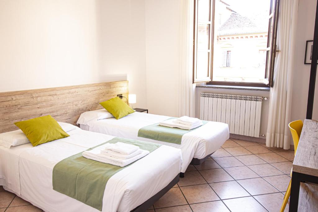 Postel nebo postele na pokoji v ubytování Hotel Tornielli 9 by LVG Hotel Collection
