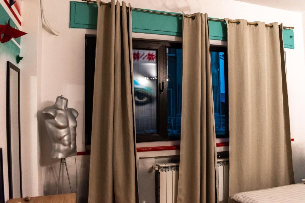 a room with a curtain with a picture of a hand at Hostel Bauhaus in Bucharest