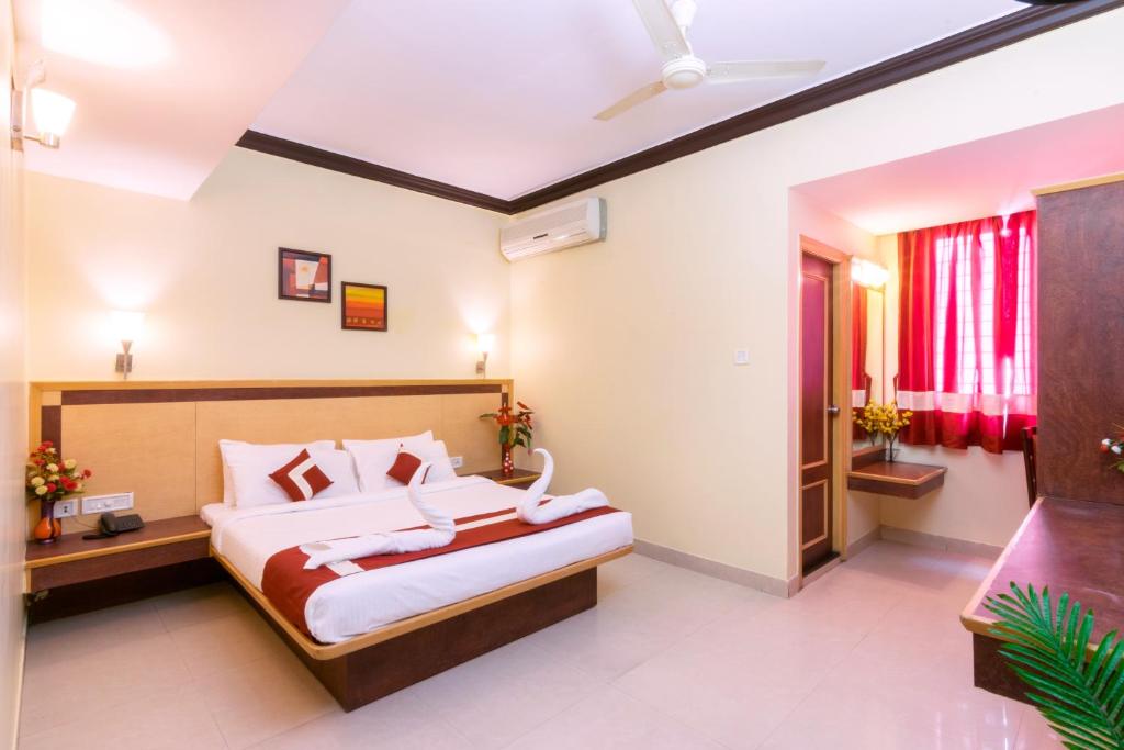 a bedroom with a large bed in a room at Octave Plaza Hotel in Bangalore