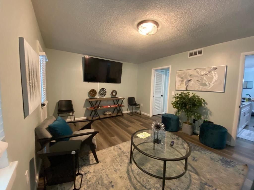 a living room with a couch and a table at HHI Homes- Newly Renovated Cozy Modern Pet-Friendly Villa-Ideal Location in Hilton Head Island