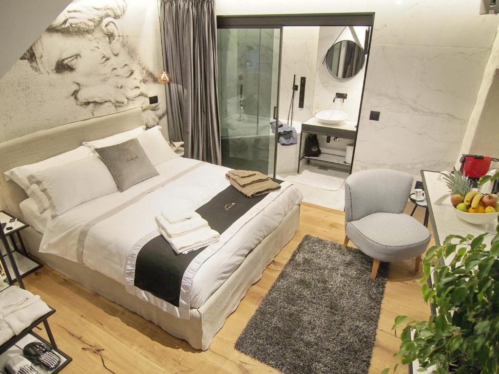 a bedroom with a king sized bed and a bathroom at La Vita e Bella III in Dubrovnik