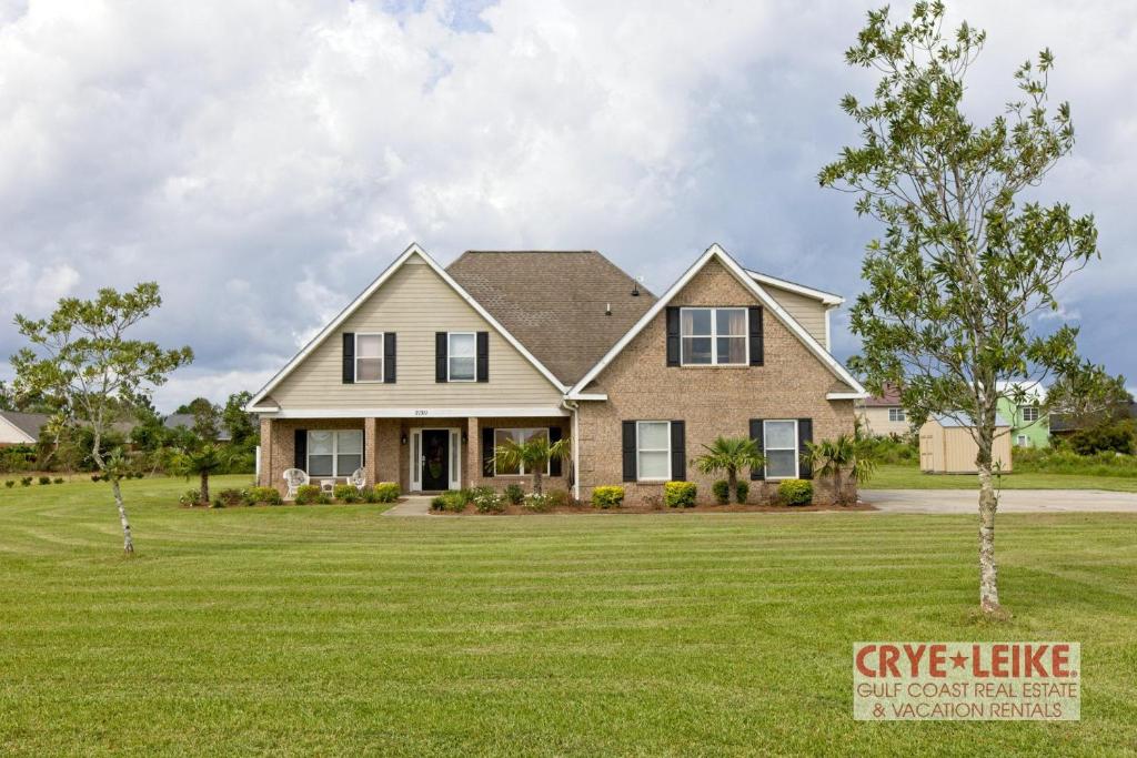 a house with a large yard at The Big Kahuna in Foley