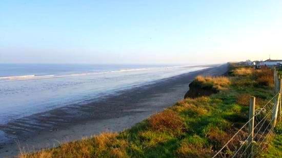 una playa vacía con una valla y el océano en 64 Southfield - Skipsea Sands en Ulrome