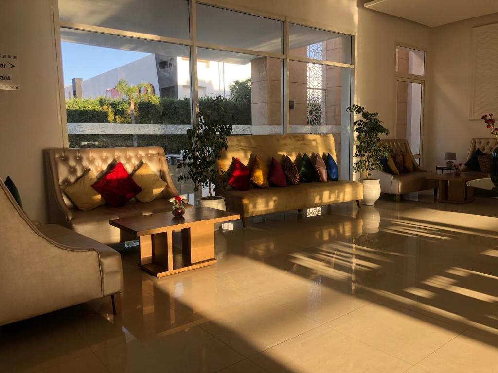 a living room with a couch and a coffee table at Relax Hôtel Oujda in Oujda
