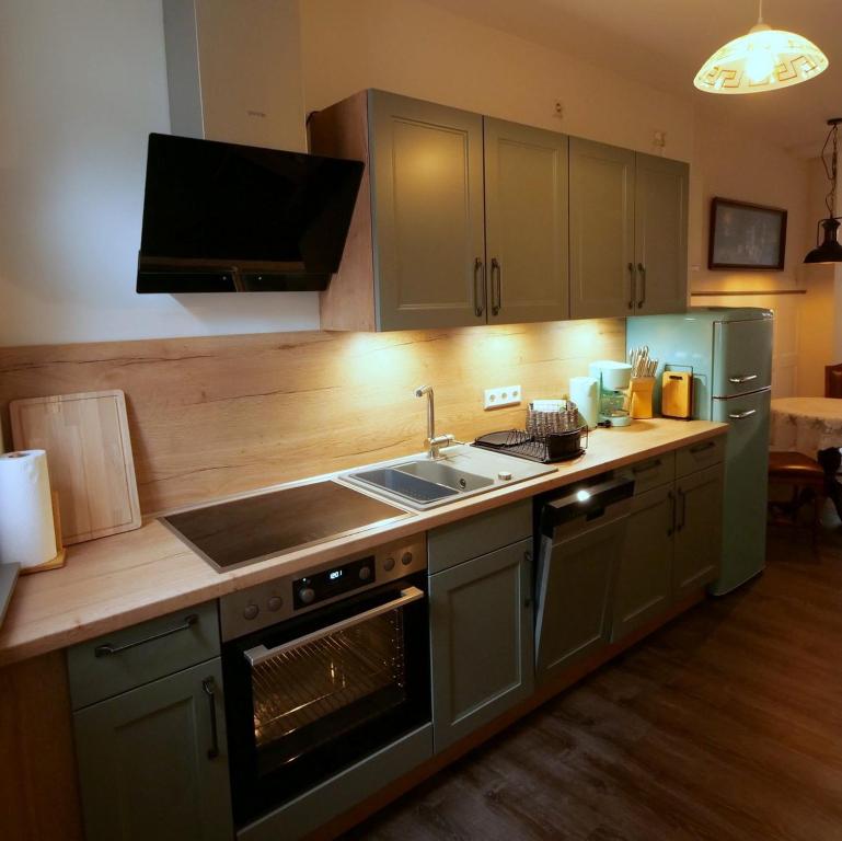 a kitchen with a sink and a stove top oven at Barrierefreie Unterkunft - Fachwerk mit Flair in Osterode