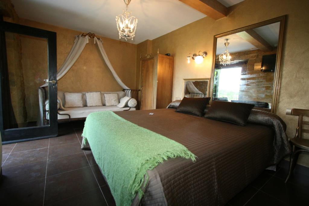 a bedroom with a large bed with a large mirror at Casona Camino de Hoz in Anero