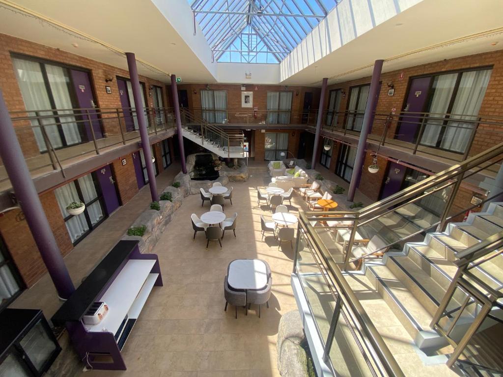 an overhead view of a building with tables and chairs at Garden Lodge Sydney Hotel in Sydney