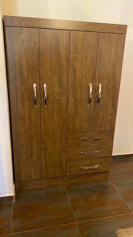 a wooden cabinet with silver handles on a wall at La Serrania B&B in Boquete