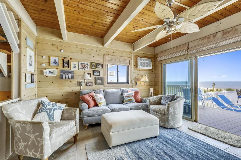 a living room with a couch and chairs and a ceiling fan at Caravelle 1 in Ocean City