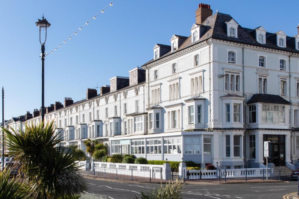 a large white building with a lot of windows at The Marine Hotel in Llandudno