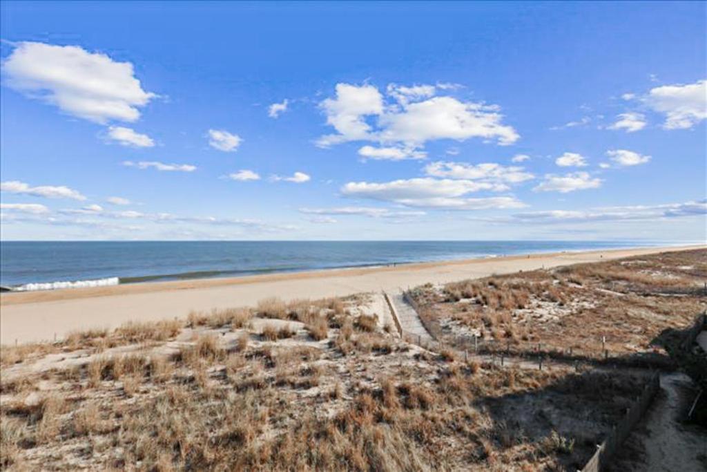 a view of a beach with the ocean in the background at Sand Dollar I 301 in Ocean City