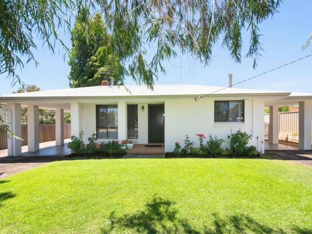 a white house with a large yard at Gale Street Retreat Busselton in Busselton