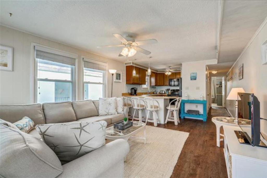 a living room with a couch and a kitchen at North Point Condo 301 in Ocean City