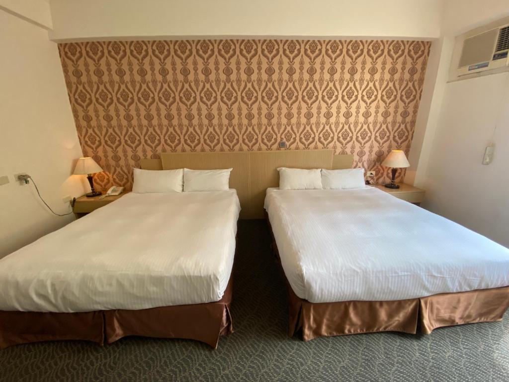 Postel nebo postele na pokoji v ubytování Dreamer Hotel