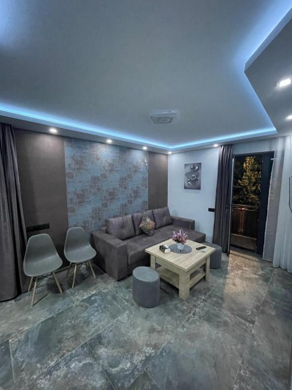 a living room with a couch and a table at Designed Apartment with French Balcony SELF CHECK IN in Yerevan