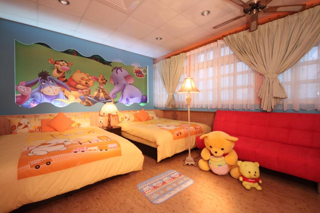 a childrens bedroom with two beds with winnie the pooh mural at Old Wind City Private Lodging in Wujie