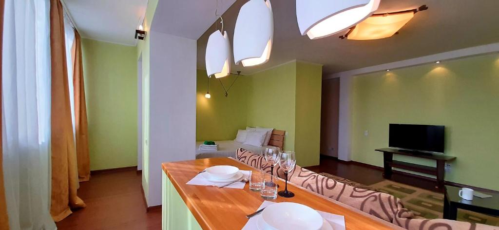 a dining room with a table and a television at Apartament on Sovetskaya 135 in Bobruisk